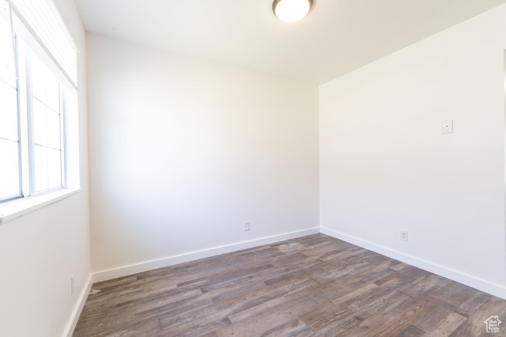 Empty room with wood finished floors and baseboards