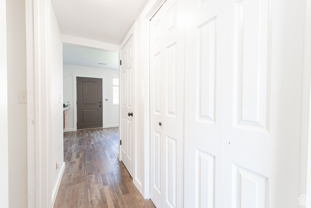 Hall with dark wood finished floors and baseboards