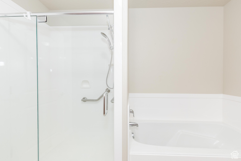 Full bath with a shower stall and a garden tub