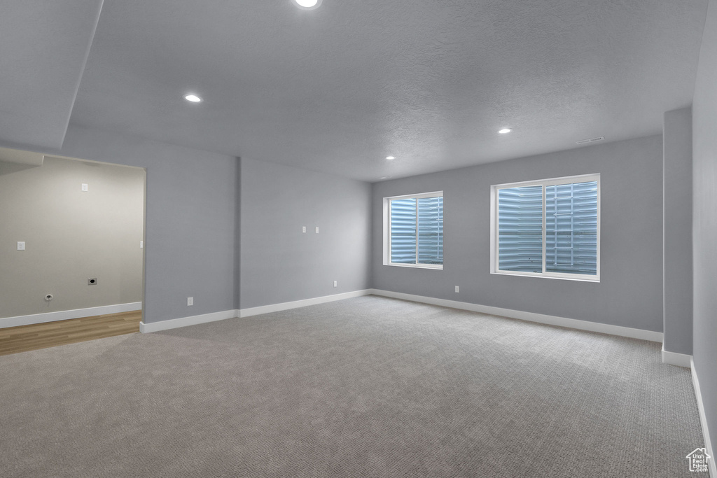 Unfurnished room featuring carpet flooring, recessed lighting, baseboards, and a textured ceiling
