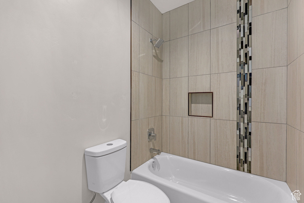 Bathroom featuring toilet and shower / bath combination