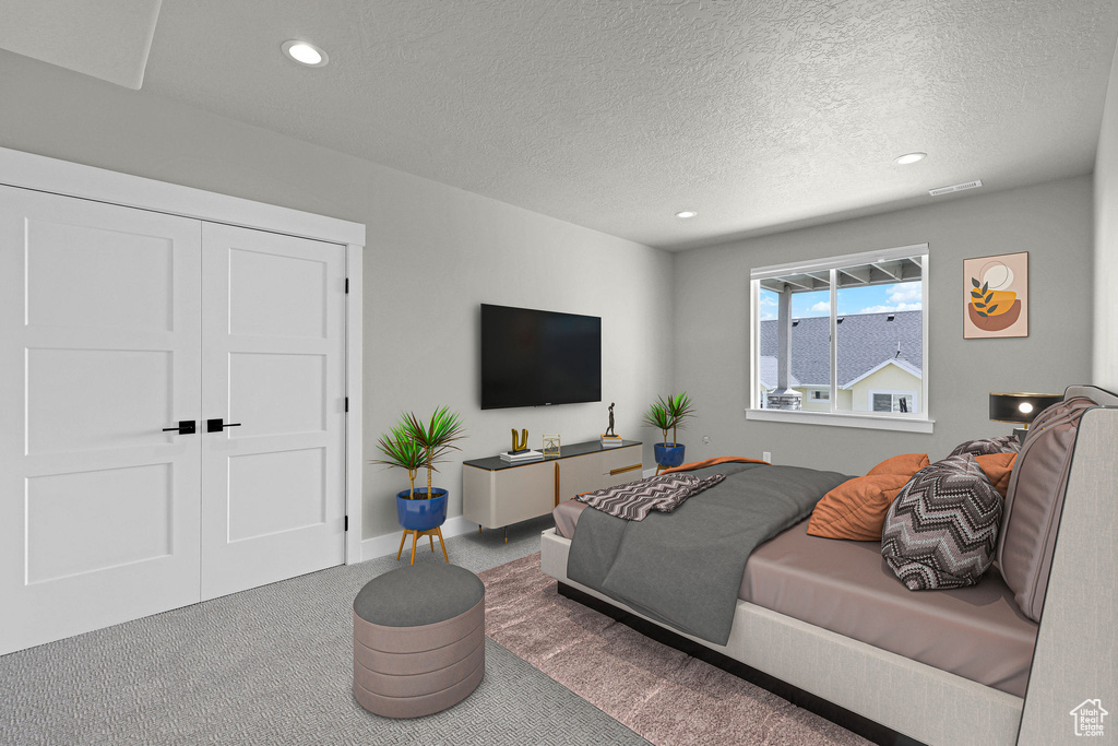 Carpeted bedroom featuring a textured ceiling and recessed lighting