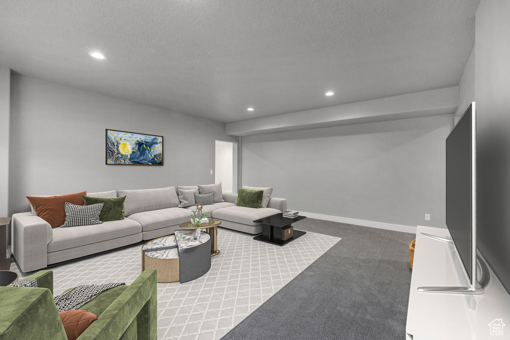 Living area with carpet flooring, recessed lighting, a textured ceiling, and baseboards