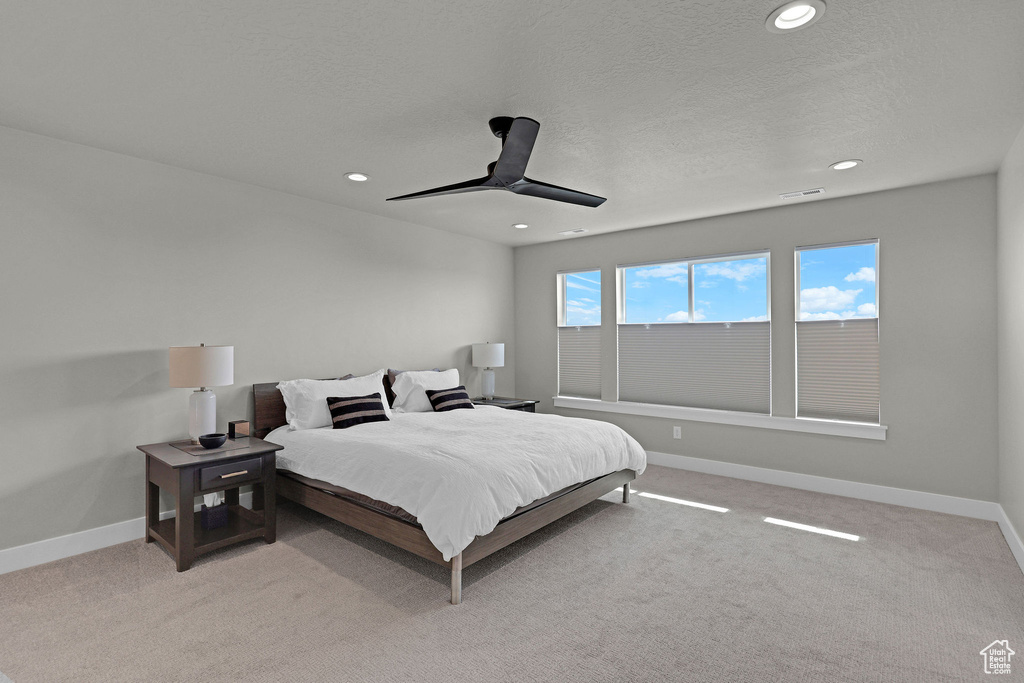 Bedroom featuring recessed lighting, baseboards, light carpet, a ceiling fan, and a textured ceiling