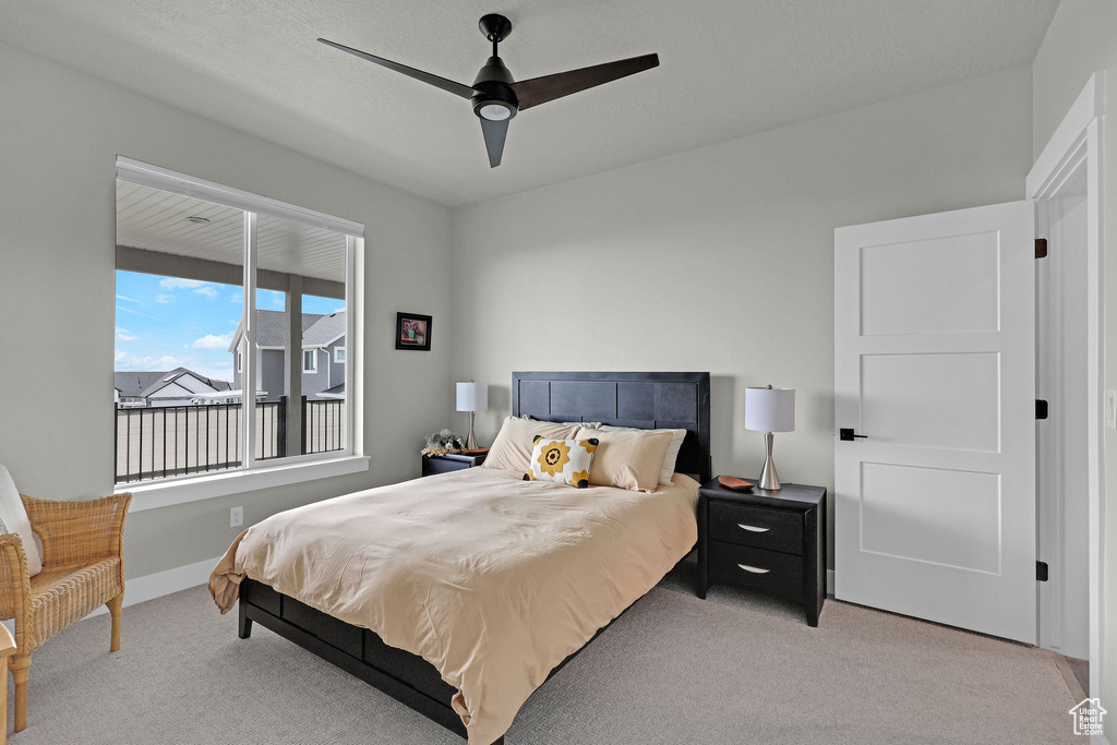 Bedroom featuring light colored carpet, ceiling fan, and baseboards