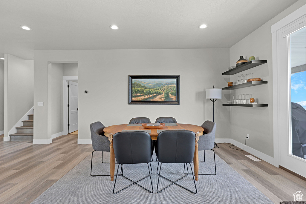 Dining area featuring stairway, light wood-type flooring, baseboards, and recessed lighting