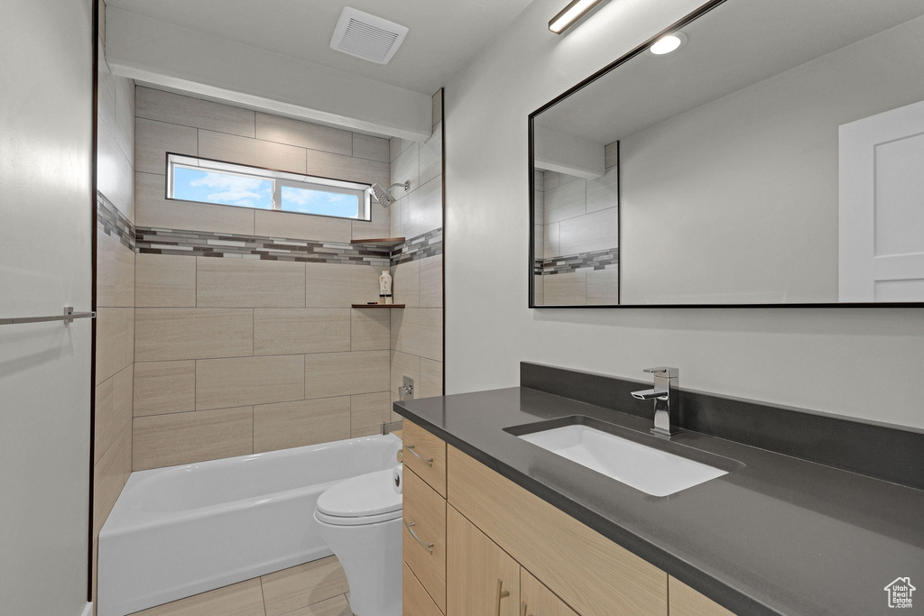 Full bathroom featuring vanity, shower / bathtub combination, and toilet