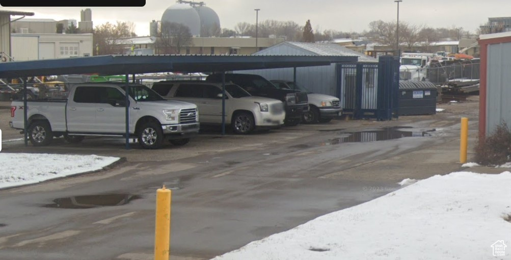 Snow covered parking featuring covered parking
