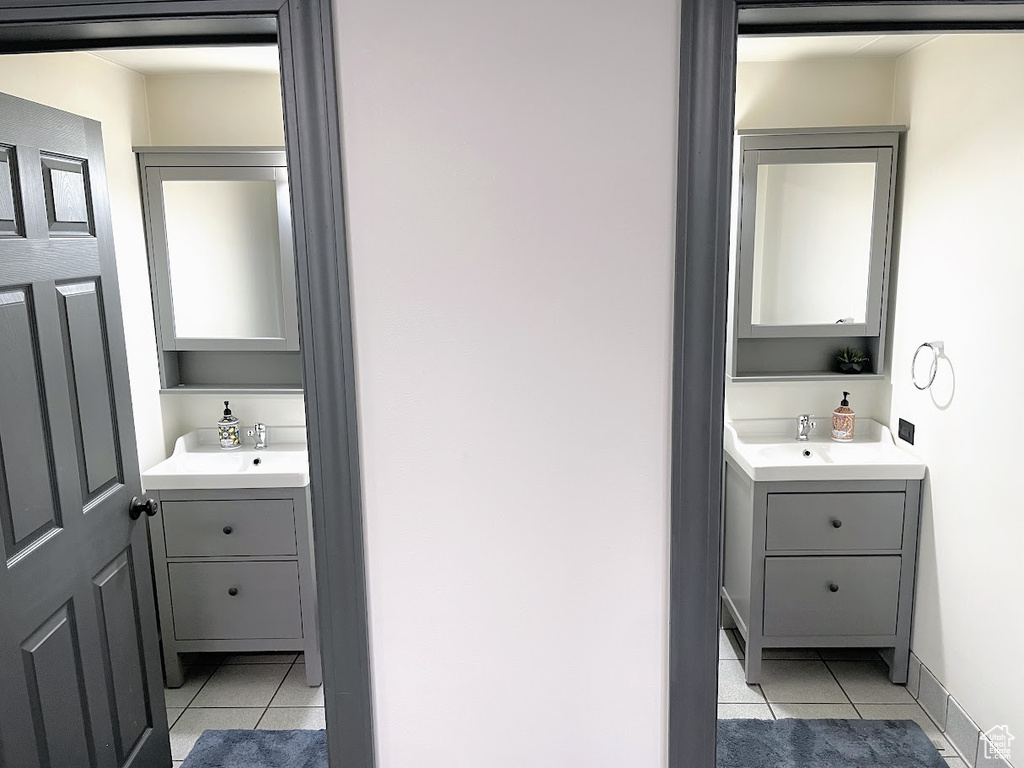 Bathroom featuring tile patterned floors and two vanities