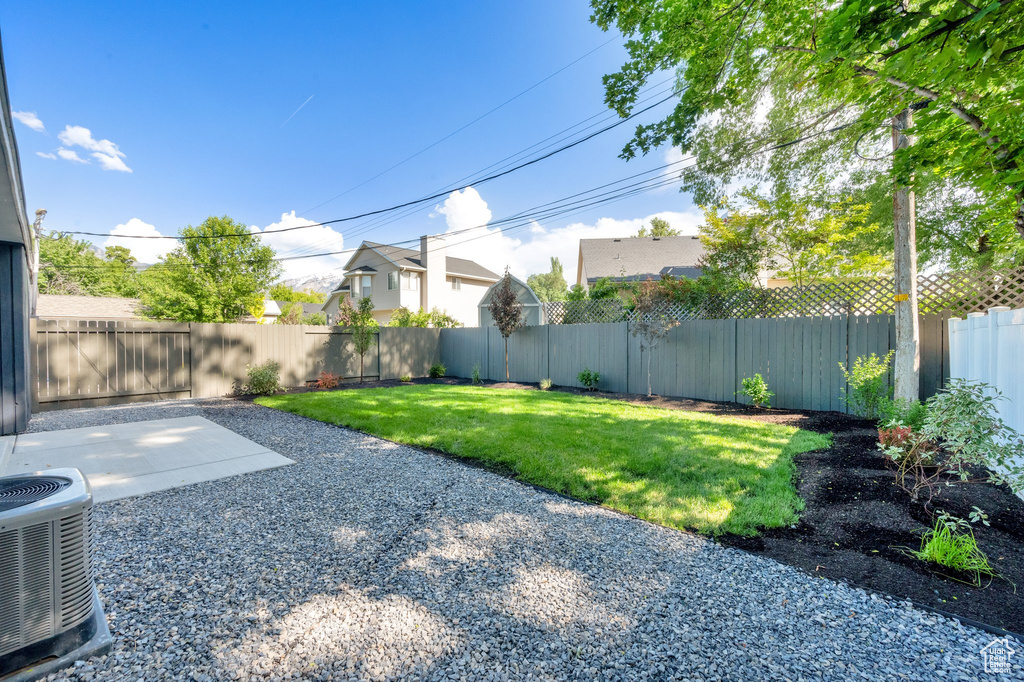 View of yard featuring central AC unit and a patio area