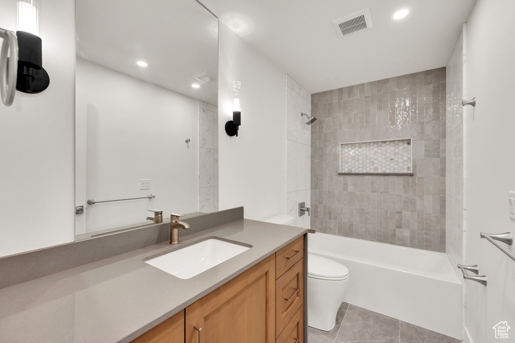Full bathroom featuring vanity, toilet, tile patterned floors, recessed lighting, and bathing tub / shower combination