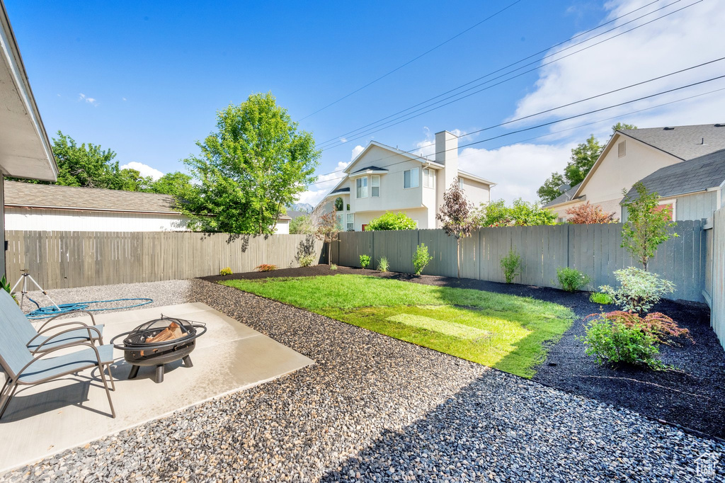 View of yard featuring an outdoor fire pit and a patio