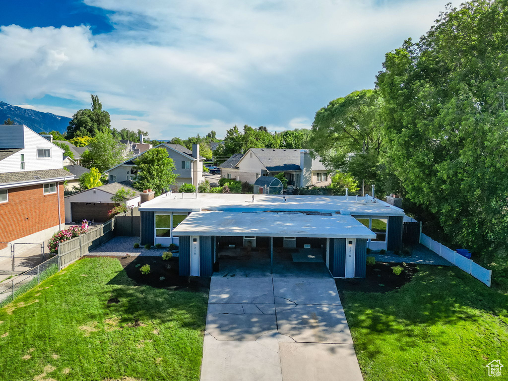 View of front facade with a residential view and driveway
