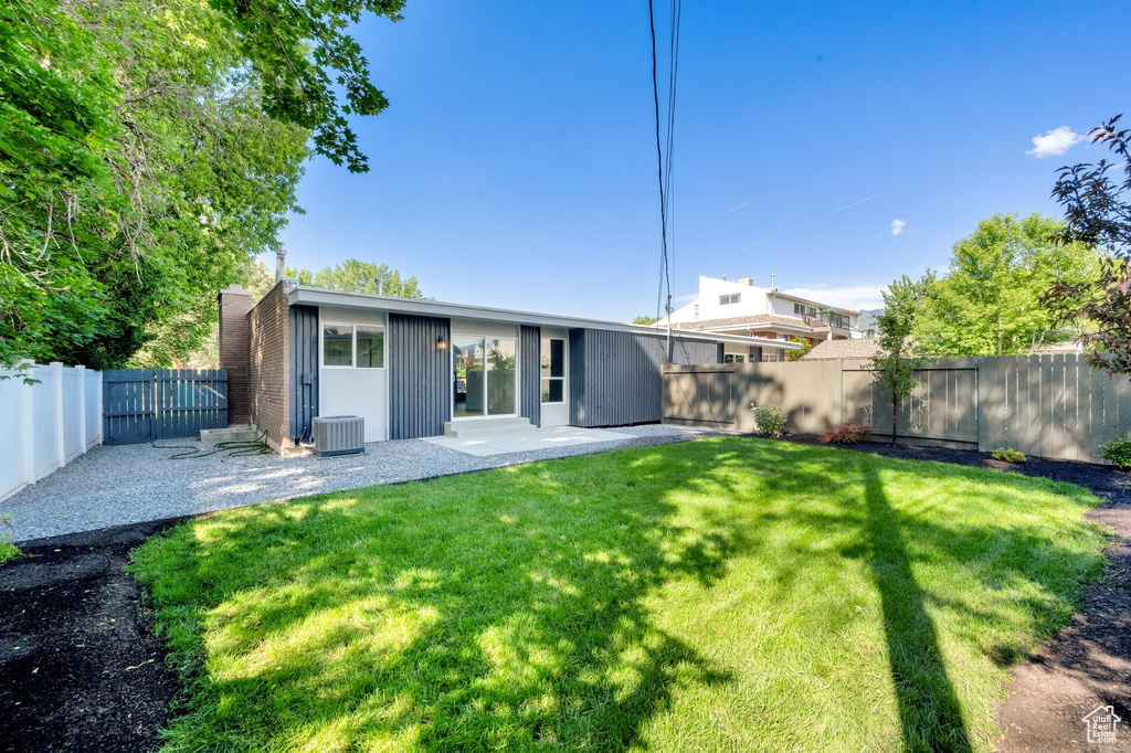 Back of property with a patio and cooling unit