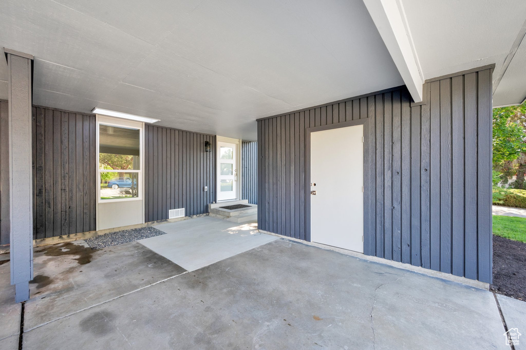 View of exterior entry featuring board and batten siding