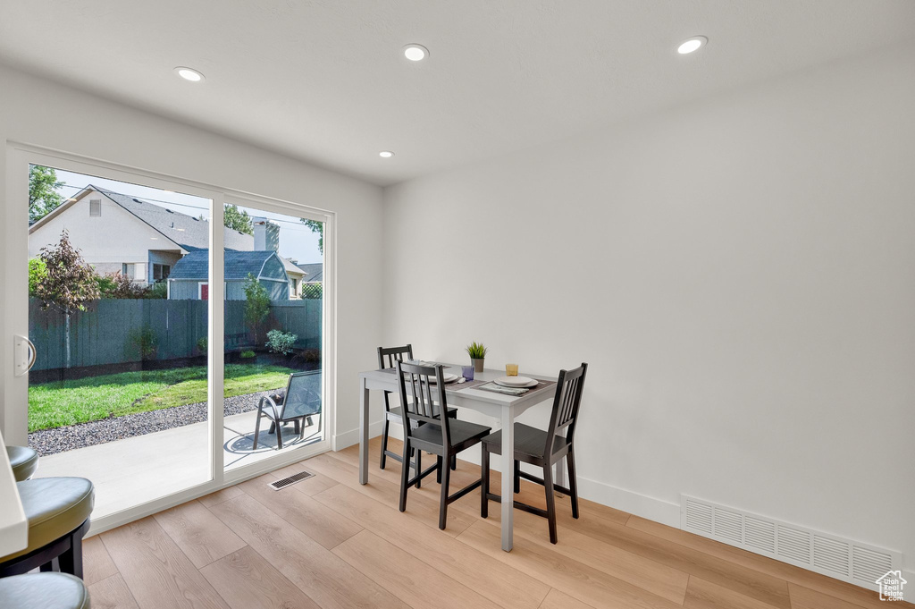 Dining area featuring light wood-style floors, recessed lighting, and baseboards