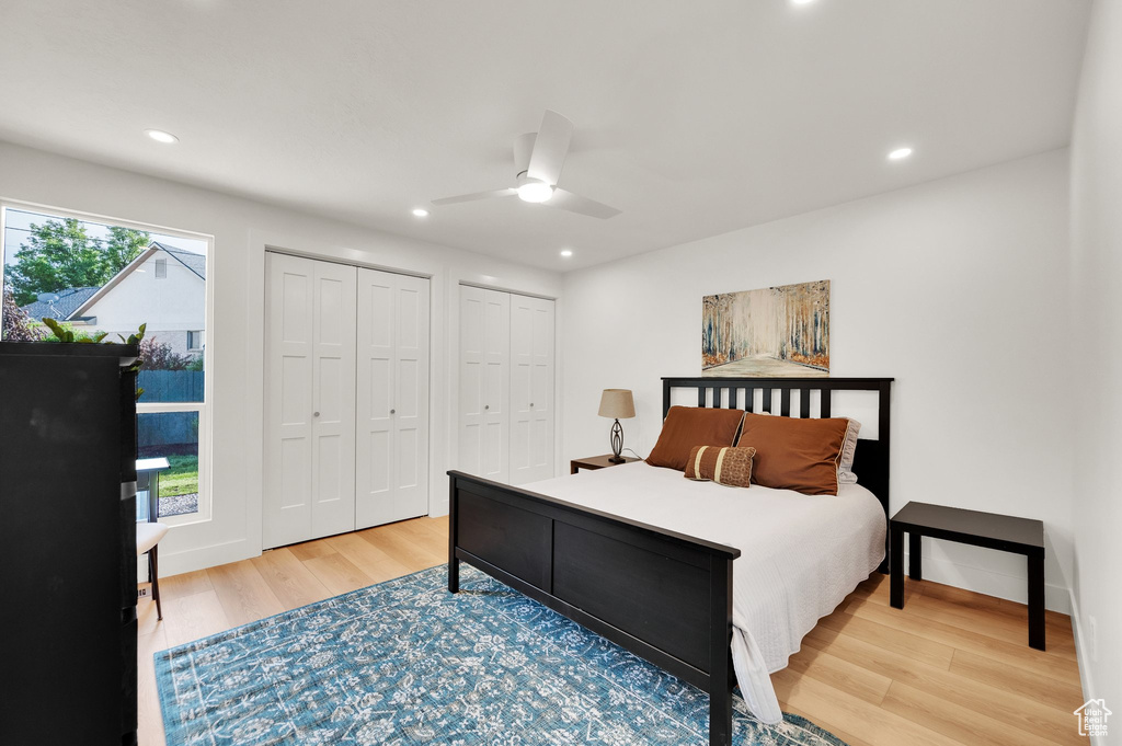 Bedroom featuring wood finished floors, two closets, recessed lighting, and ceiling fan