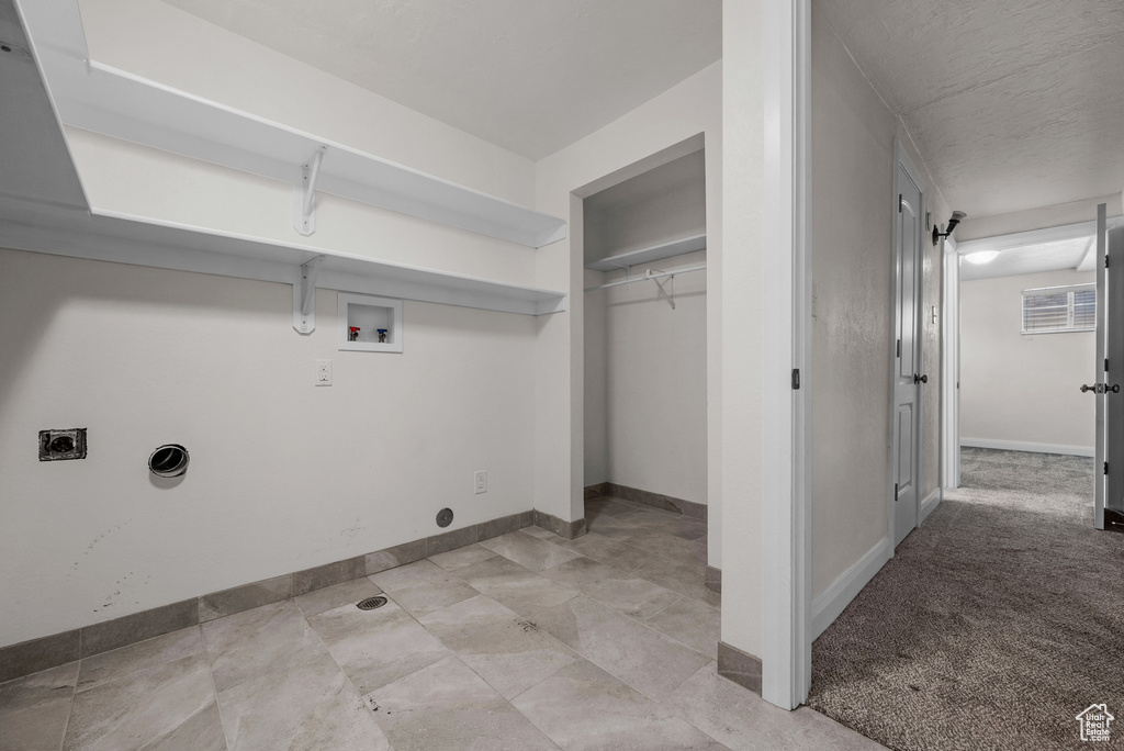 Washroom featuring hookup for a washing machine, electric dryer hookup, and baseboards