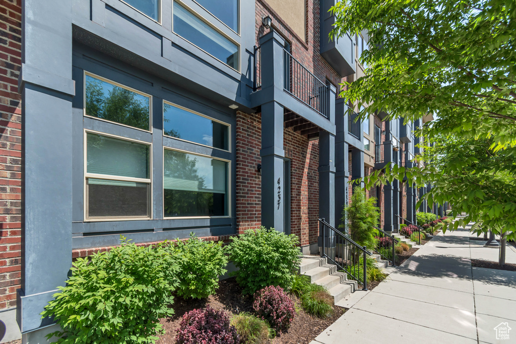 Property entrance featuring brick siding and stucco siding