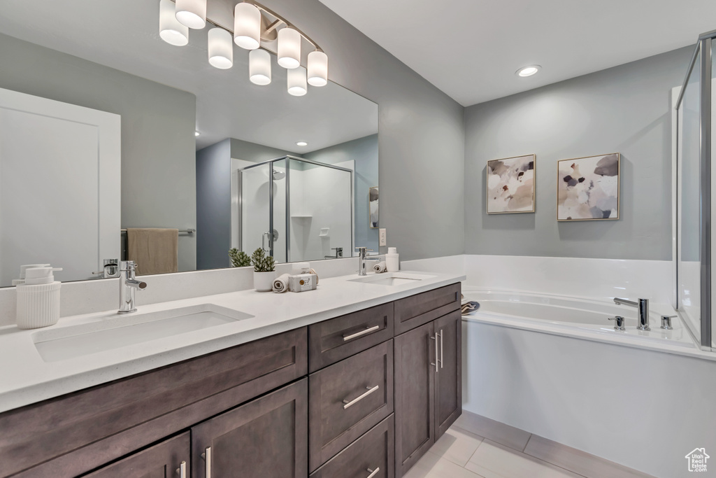 Full bath featuring a stall shower, double vanity, a garden tub, tile patterned floors, and recessed lighting