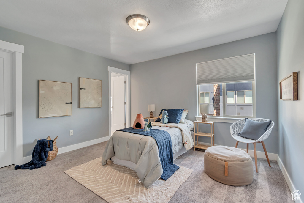Carpeted bedroom featuring baseboards