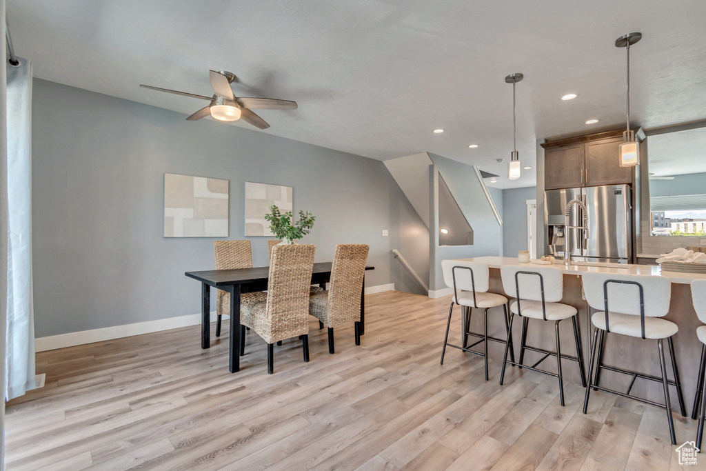Dining area featuring light wood finished floors, ceiling fan, recessed lighting, and baseboards