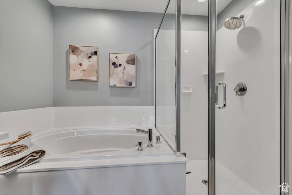 Full bath with a shower stall and a garden tub
