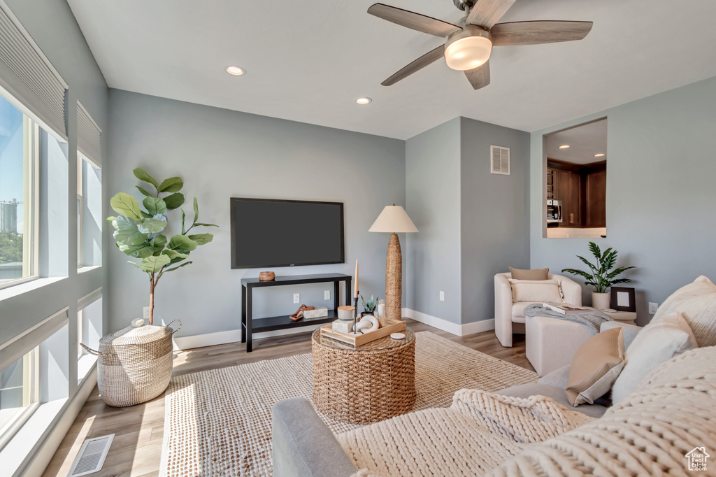 Living area featuring wood finished floors, recessed lighting, baseboards, and ceiling fan