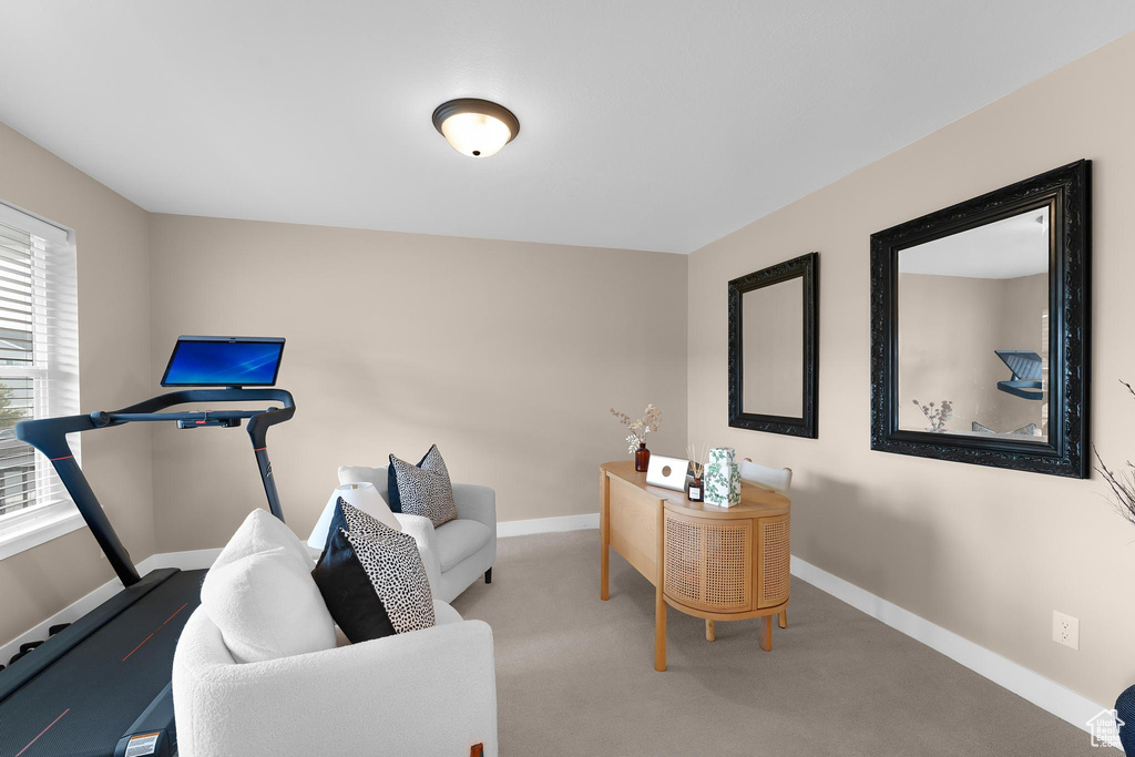 Home office with baseboards and carpet floors