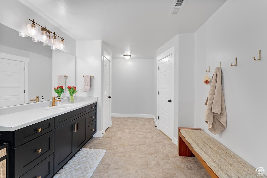 Bathroom featuring vanity and baseboards