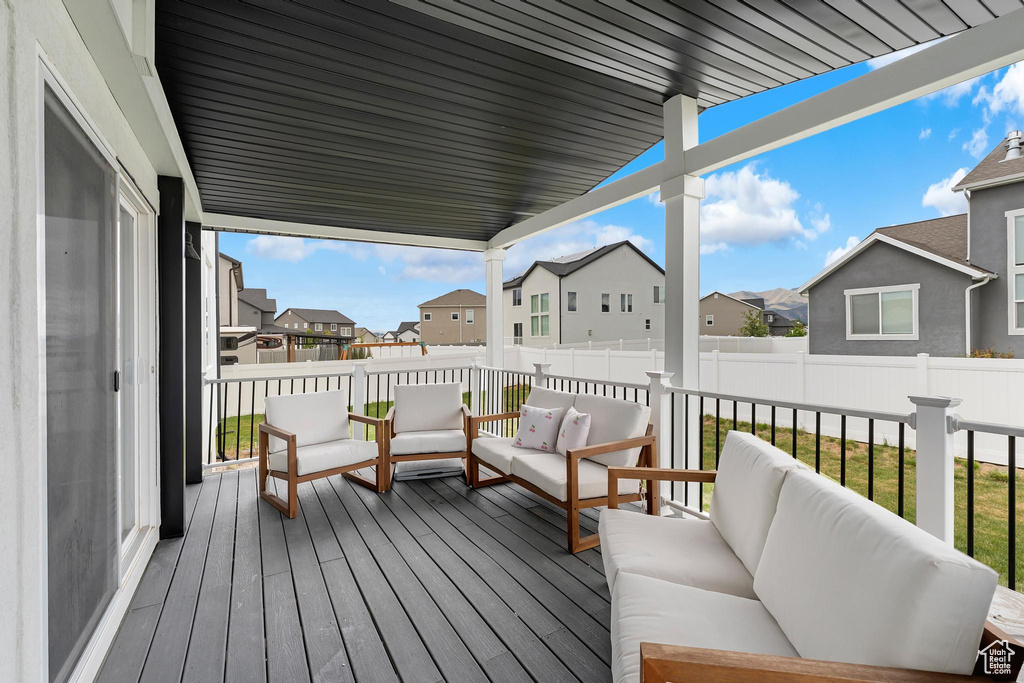 Deck featuring a residential view, an outdoor living space, and a fenced backyard