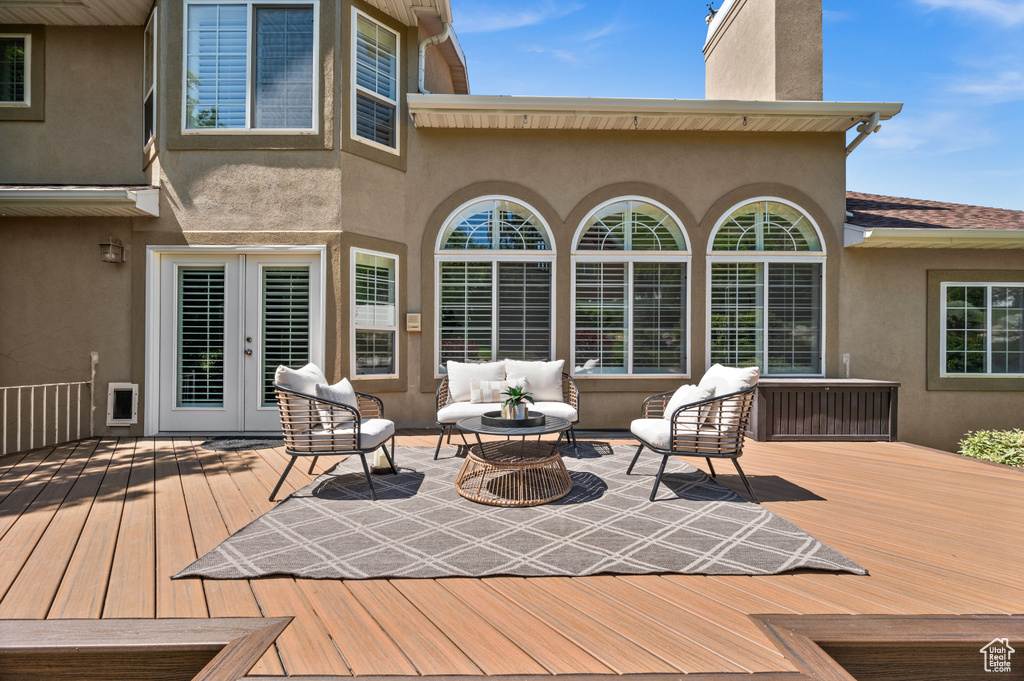Wooden terrace featuring french doors and outdoor lounge area