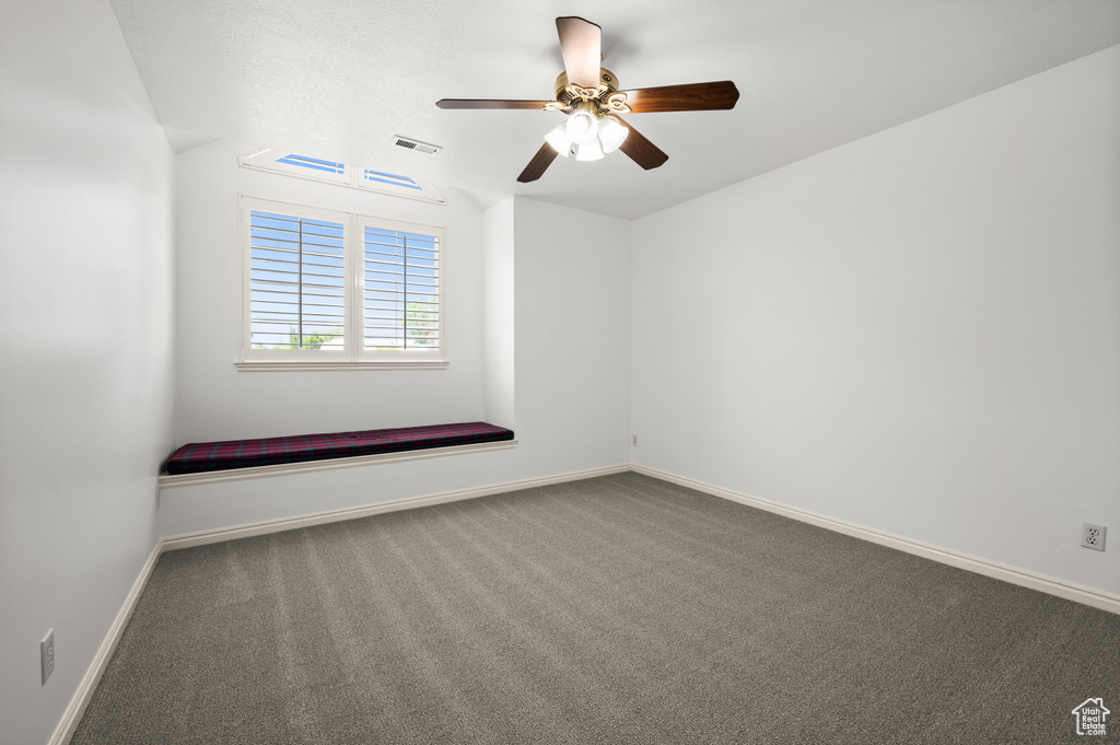 Unfurnished room featuring carpet, ceiling fan, and baseboards