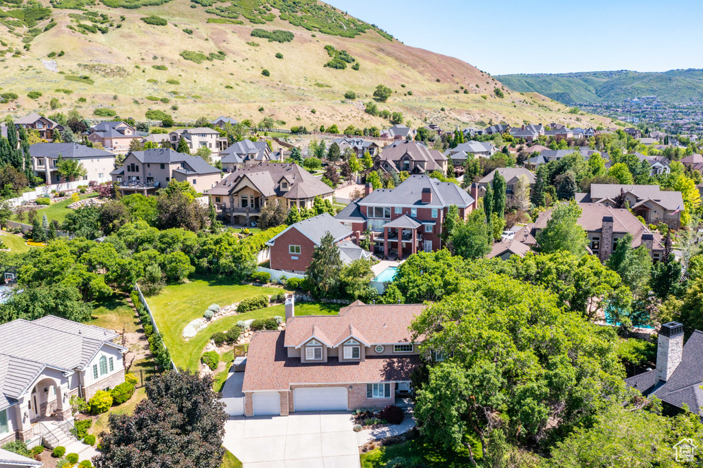 Aerial perspective of suburban area featuring a mountainous background