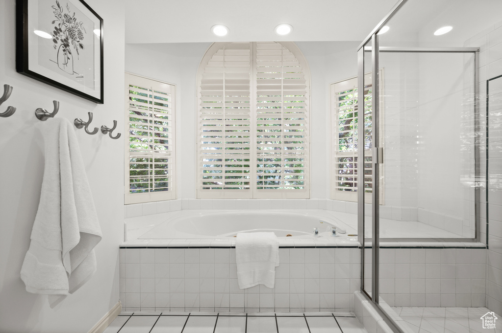 Bathroom with plenty of natural light, a bath, recessed lighting, a stall shower, and tile patterned floors