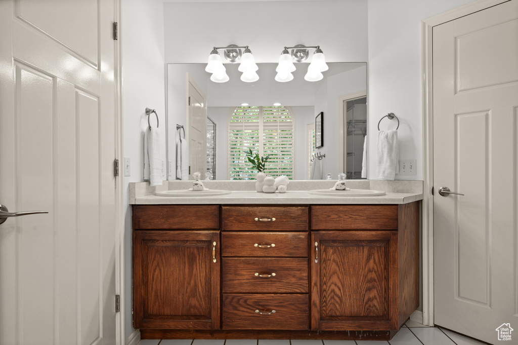 Bathroom featuring double vanity and tile patterned flooring