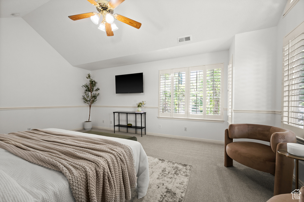 Bedroom with carpet flooring, vaulted ceiling, baseboards, and ceiling fan