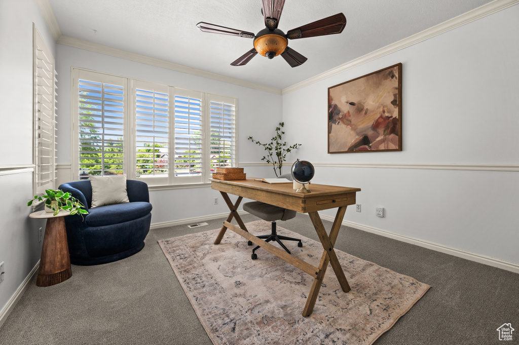 Home office with carpet flooring, baseboards, ornamental molding, and a ceiling fan