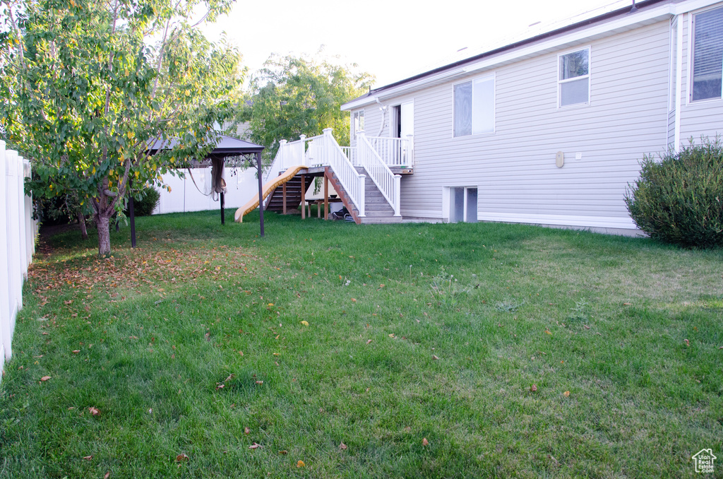 View of yard featuring stairs and a deck