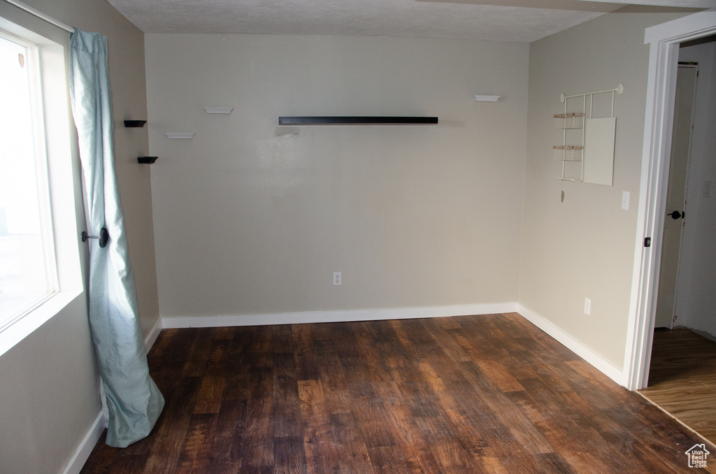 Spare room featuring wood finished floors and baseboards