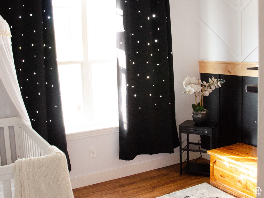 Bedroom featuring wood finished floors and baseboards