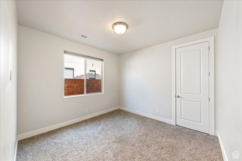 Spare room with carpet flooring and baseboards