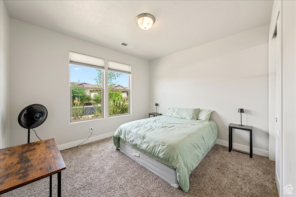 Carpeted bedroom with baseboards