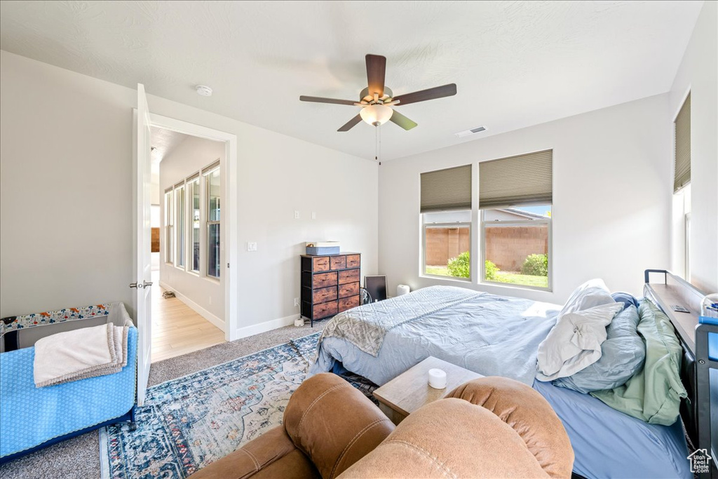 Bedroom featuring carpet floors, a ceiling fan, and baseboards