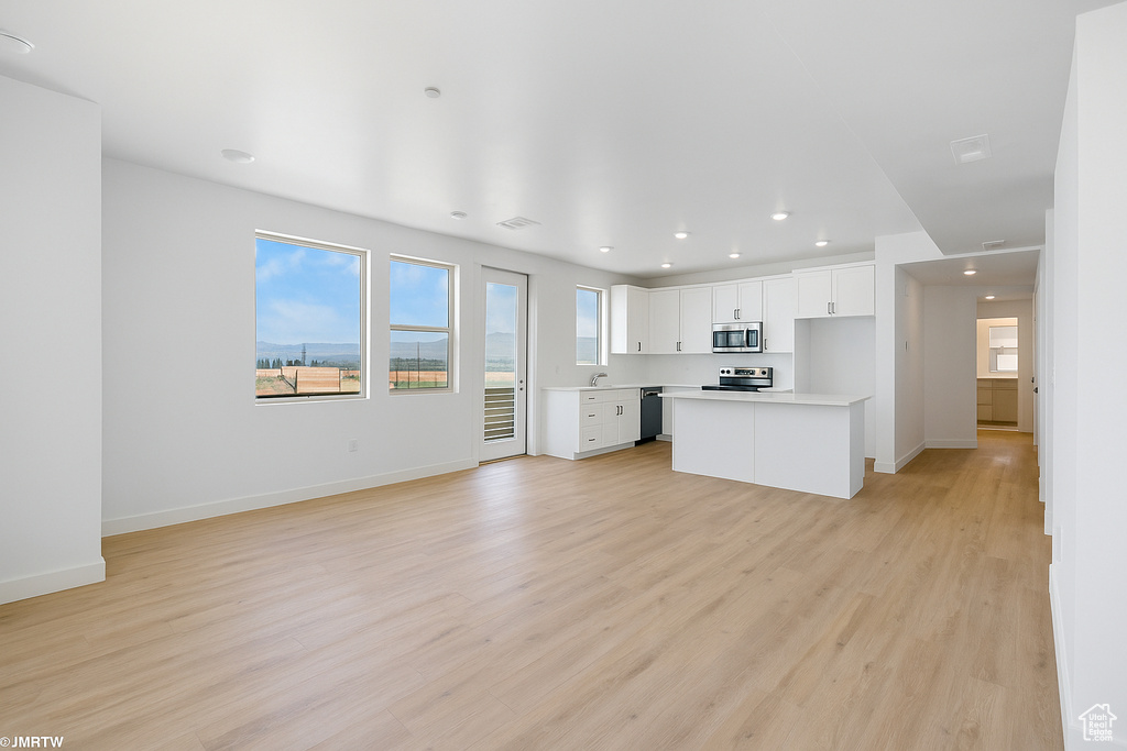 Unfurnished living room featuring recessed lighting and light wood-style floors