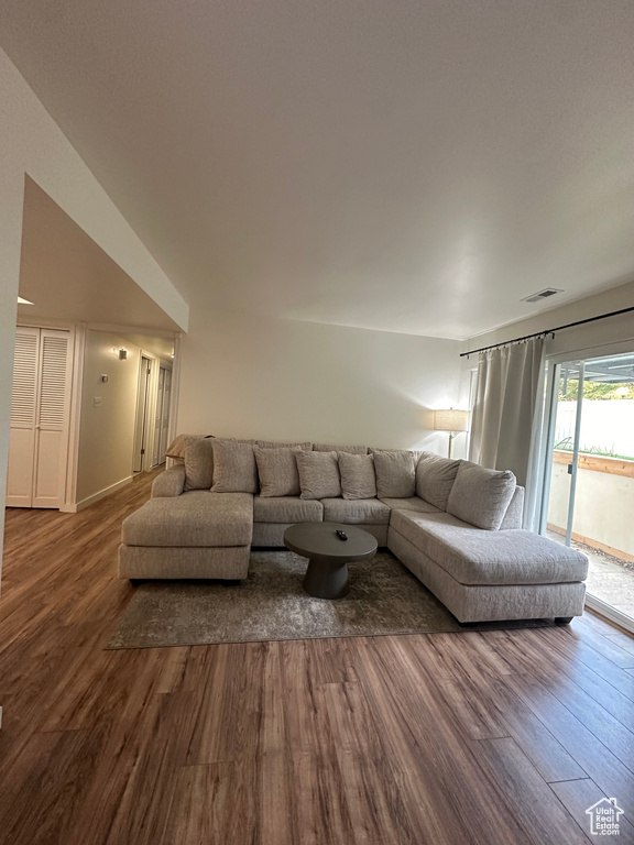 Living area with dark wood-type flooring