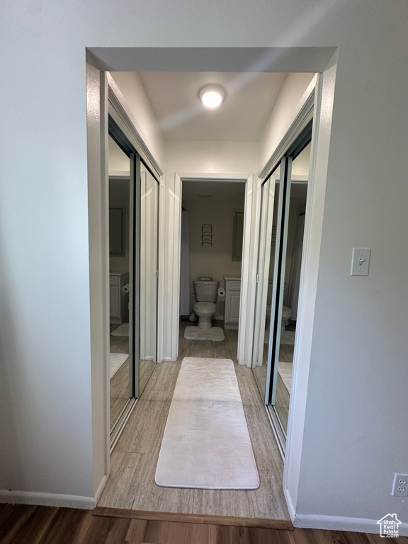 Corridor featuring wood finished floors and baseboards