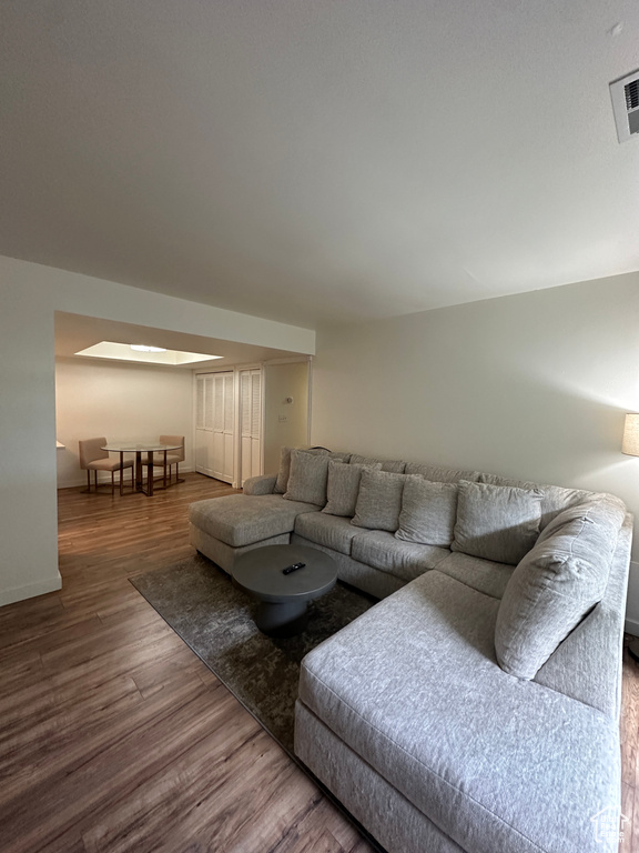 Living room with wood finished floors and baseboards