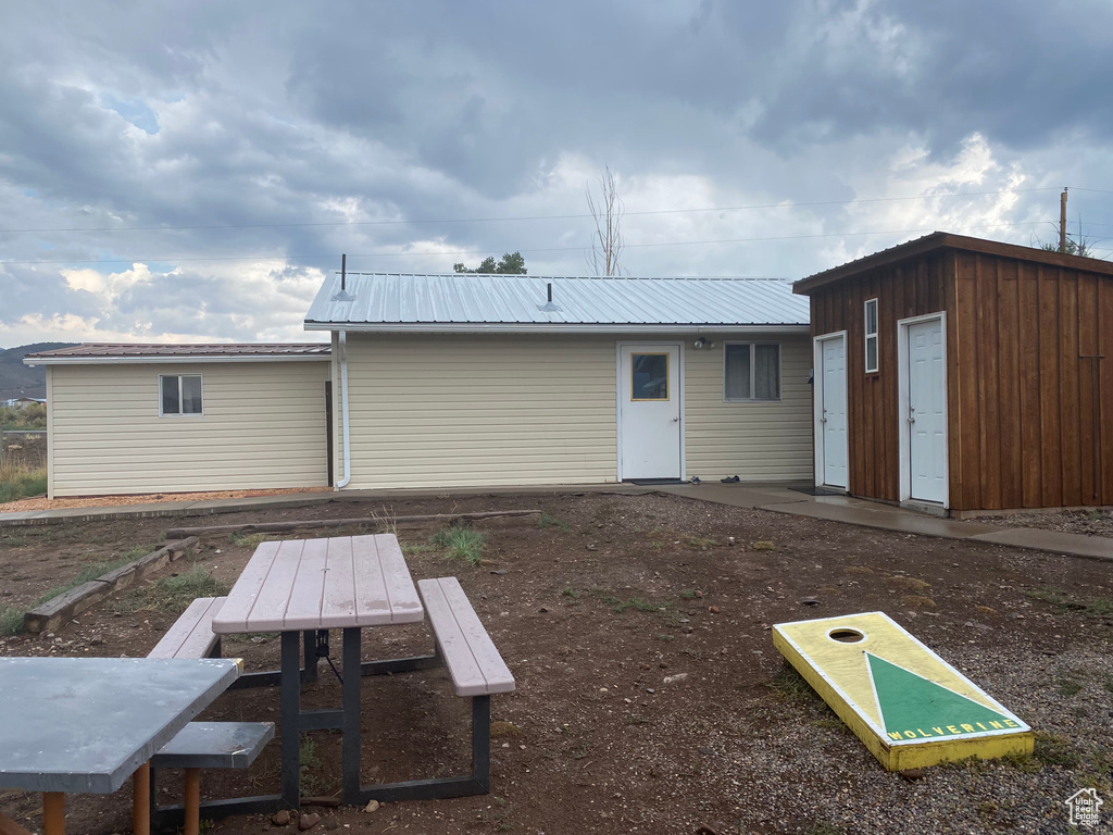 Back of property with metal roof