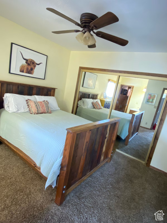 Carpeted bedroom featuring a ceiling fan